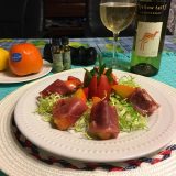PERSIMMONS WRAPPED IN PROSCIUTTO HAM WITH FRISEE SALAD SPRINKLED WITH ARGAN OIL